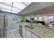 Well-lit kitchen open to the living area featuring granite countertops, stainless steel appliances, and ample counter space at 440 S Gulfview Blvd # 701, Clearwater Beach, FL 33767