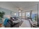 Comfortable living room with modern decor, ceiling fan, and sliding glass doors leading to a scenic balcony at 440 S Gulfview Blvd # 701, Clearwater Beach, FL 33767