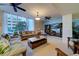 Comfortable living area with large windows, ceiling fans, and stylish furnishings at 440 S Gulfview Blvd # 701, Clearwater Beach, FL 33767