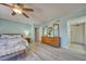 The bedroom showcases a comfortable bed, dresser, wood-look floors and a ceiling fan at 440 S Gulfview Blvd # 701, Clearwater Beach, FL 33767