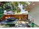 Relax on the wooden deck in this backyard with an outdoor dining set and seating area at 4505 S Clark Ave, Tampa, FL 33611