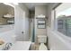 Bright bathroom featuring a vanity, toilet, shower with fresh white towels, and window at 4505 S Clark Ave, Tampa, FL 33611