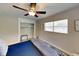 Well lit bedroom featuring ceiling fan, closet space, and comfortable bed at 4505 S Clark Ave, Tampa, FL 33611