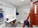 Bright bedroom featuring built-in shelves, a white desk, and modern decor at 4505 S Clark Ave, Tampa, FL 33611