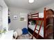 Cozy bedroom featuring a wooden bunk bed, white desk, and stylish decor elements at 4505 S Clark Ave, Tampa, FL 33611
