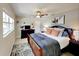 Spacious bedroom with ceiling fan, dresser, and large bed with decorative pillows at 4505 S Clark Ave, Tampa, FL 33611