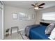 This cozy bedroom features a ceiling fan, bright windows, and calming decor at 4505 S Clark Ave, Tampa, FL 33611
