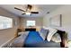 Comfortable bedroom features a ceiling fan, bright windows, and cozy pillows at 4505 S Clark Ave, Tampa, FL 33611