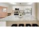 Bright kitchen featuring white cabinetry, granite countertops, and a spacious central island at 4505 S Clark Ave, Tampa, FL 33611