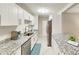 Well-appointed kitchen with white cabinets, stainless steel appliances, and granite countertops at 4505 S Clark Ave, Tampa, FL 33611