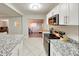 Modern kitchen showcasing stainless steel appliances and elegant granite countertops at 4505 S Clark Ave, Tampa, FL 33611