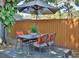 Backyard patio area featuring a table with seating and a large umbrella for shade at 4505 S Clark Ave, Tampa, FL 33611