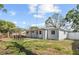 Backyard features outdoor dining space and privacy fence at 4718 W Oklahoma Ave, Tampa, FL 33616