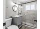 Bathroom featuring a sink vanity and a walk-in shower with a dark-framed glass door at 4718 W Oklahoma Ave, Tampa, FL 33616