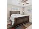 Bedroom featuring a ceiling fan, two windows, wood-look flooring, and a traditional-style bed frame at 4718 W Oklahoma Ave, Tampa, FL 33616