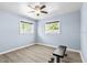 Bedroom featuring light blue walls, a weight bench, and luxury vinyl plank flooring at 4718 W Oklahoma Ave, Tampa, FL 33616
