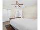 Bedroom featuring a ceiling fan, a closet, wood-look flooring, and a traditional-style bed frame at 4718 W Oklahoma Ave, Tampa, FL 33616