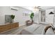Comfortable bedroom featuring neutral walls, light wood floors, and modern furniture at 4718 W Oklahoma Ave, Tampa, FL 33616