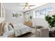 Cozy bedroom featuring abundant natural light, wood-look flooring, and a stylish dresser at 4718 W Oklahoma Ave, Tampa, FL 33616