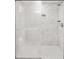 Walk-in shower features marble walls, glass door, and hexagon tile flooring at 4718 W Oklahoma Ave, Tampa, FL 33616