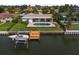 Aerial view of waterfront property with pool, boat dock, and lush landscaping at 4754 Overlook Ne Dr, St Petersburg, FL 33703