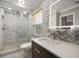 Modern bathroom showcasing a glass-enclosed shower, designer tiles, and a contemporary vanity with ample natural light at 4754 Overlook Ne Dr, St Petersburg, FL 33703