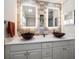 Elegant bathroom with dual vessel sinks, decorative lit mirrors, tiled accent wall and modern fixtures at 4754 Overlook Ne Dr, St Petersburg, FL 33703