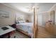 Cozy bedroom featuring a decorative bed, ample storage, natural light, and a view of the backyard at 4754 Overlook Ne Dr, St Petersburg, FL 33703
