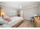 Comfortable bedroom with a four-poster bed, wood-look floors, and a ceiling fan at 4754 Overlook Ne Dr, St Petersburg, FL 33703