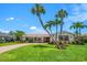 Charming single-story home with lush lawn, beautiful palms and a brick driveway at 4754 Overlook Ne Dr, St Petersburg, FL 33703