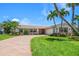 Well-manicured front yard with palm trees leads to this beautiful one story home with brick driveway at 4754 Overlook Ne Dr, St Petersburg, FL 33703