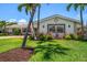 Landscaped front yard with beautiful palms and plants around a charming home at 4754 Overlook Ne Dr, St Petersburg, FL 33703