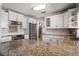 Well-lit kitchen featuring white cabinets, granite countertops, stainless steel appliances, and ample counter space at 4754 Overlook Ne Dr, St Petersburg, FL 33703