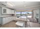 Well-lit kitchen featuring white cabinets, granite countertops, and a breakfast bar overlooking the canal at 4754 Overlook Ne Dr, St Petersburg, FL 33703