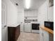 Well-organized laundry room with modern washer/dryer, storage cabinets, and countertop space at 4754 Overlook Ne Dr, St Petersburg, FL 33703