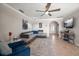 Bright living room with tile floor, ceiling fan, comfortable seating, and an arched entry adds to the space's architectural detail at 4754 Overlook Ne Dr, St Petersburg, FL 33703