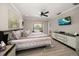 Serene main bedroom with private access to the pool area, complete with a ceiling fan and modern décor at 4754 Overlook Ne Dr, St Petersburg, FL 33703