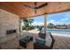 Inviting outdoor living area with fireplace, comfortable seating, and a view of the pool at 4754 Overlook Ne Dr, St Petersburg, FL 33703