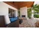 Relaxing outdoor space with a stone fireplace, wicker furniture, and lush tropical landscaping at 4754 Overlook Ne Dr, St Petersburg, FL 33703