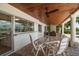 Spacious covered patio with a dining area, fireplace, and waterfront views at 4754 Overlook Ne Dr, St Petersburg, FL 33703