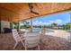 Covered patio with a dining set and views of the pool, canal and outdoor area at 4754 Overlook Ne Dr, St Petersburg, FL 33703