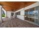 Covered patio with dining set, views of the pool, and sliding glass doors to the interior at 4754 Overlook Ne Dr, St Petersburg, FL 33703