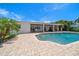 Backyard features a beautiful in-ground pool, brick paver deck, and covered patio for outdoor enjoyment at 4754 Overlook Ne Dr, St Petersburg, FL 33703