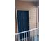 Stylish unit front door with decorative door knocker, unit number, and adjacent outdoor railing at 5000 Culbreath Key Way # 1-220, Tampa, FL 33611