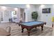 A well-appointed game room features a classic pool table, decorative tree, and elegant wainscoting at 5000 Culbreath Key Way # 1-220, Tampa, FL 33611