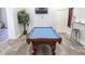 A well-appointed game room features a classic pool table, decorative tree, and elegant wainscoting at 5000 Culbreath Key Way # 1-220, Tampa, FL 33611