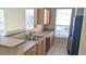 Cozy kitchen featuring light cabinets, tile floors, and a breakfast bar at 5000 Culbreath Key Way # 1-220, Tampa, FL 33611