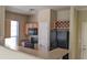 Kitchen featuring black appliances, a breakfast bar, and light cabinets at 5000 Culbreath Key Way # 1-220, Tampa, FL 33611