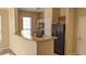Kitchen area featuring black appliances, light cabinets, and a breakfast bar at 5000 Culbreath Key Way # 1-220, Tampa, FL 33611