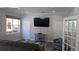 Comfortable living room with sofa, TV, neutral paint, wood-look floors and a sunlit window at 5000 Culbreath Key Way # 1-220, Tampa, FL 33611